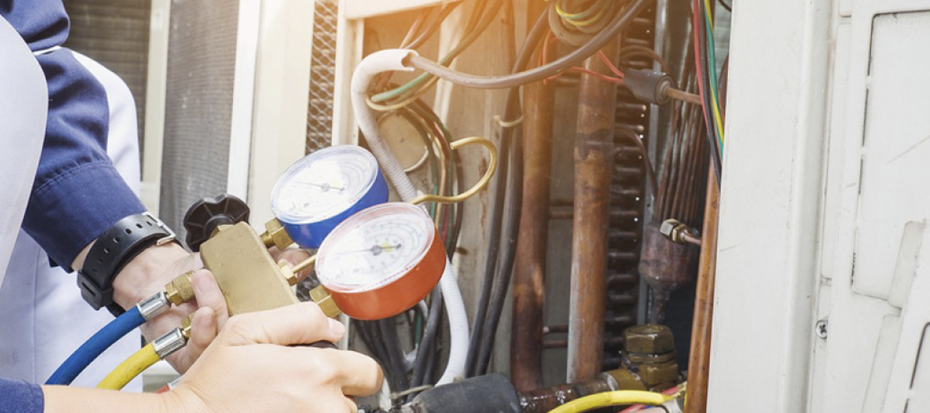 Service technician checking air handler