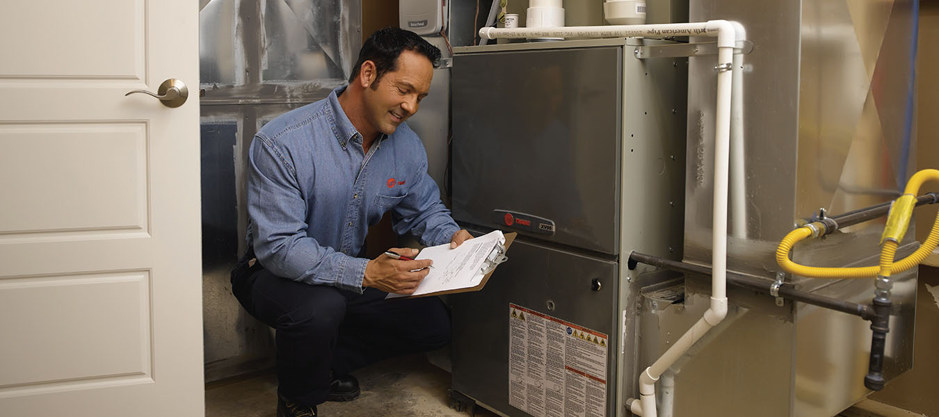 Service technician next to heater