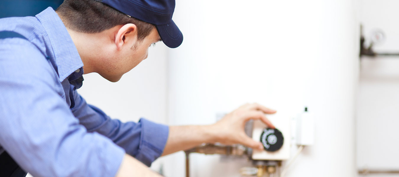 service technician adjusting boiler