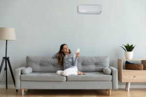 Woman On Couch Enjoying Ductless Heat