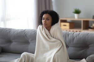 Woman Wrapped In Blanket Feeling Cold
